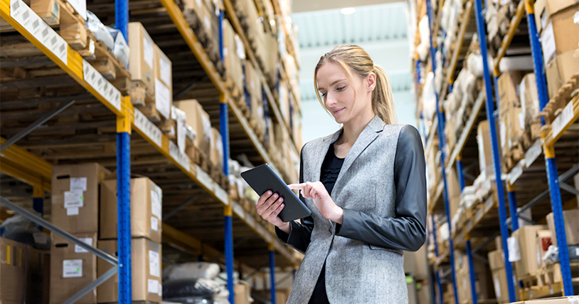 Woman using networking technology in a warehouse