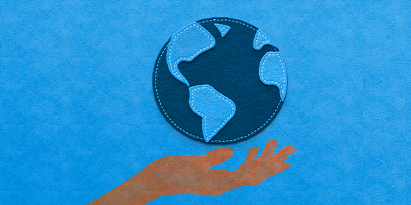 Hand holding a globe representative of Earth Day