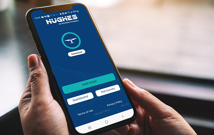 Person holding phone with Hughes LEO App