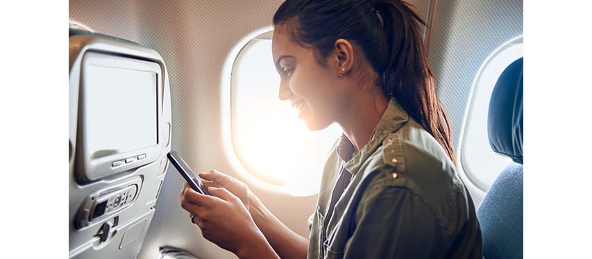 woman_using_phone_on_plane