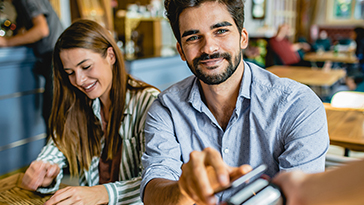 man paying for meal in restaurant