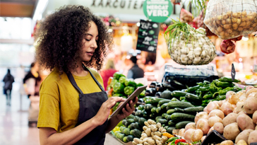 woman on tablet at grocery store