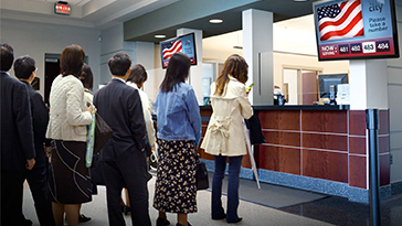 People standing in line at state government building