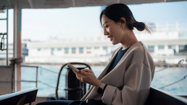 Woman using device on ferry