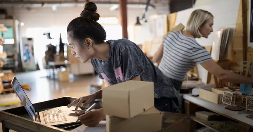 Franchise employee working on laptop