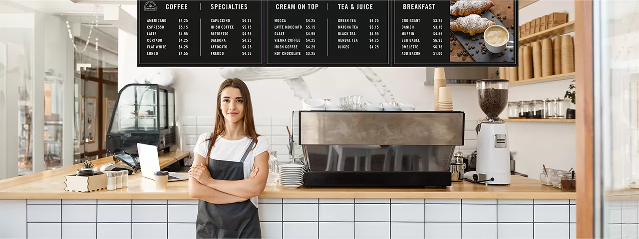 barista in front of digital menu board