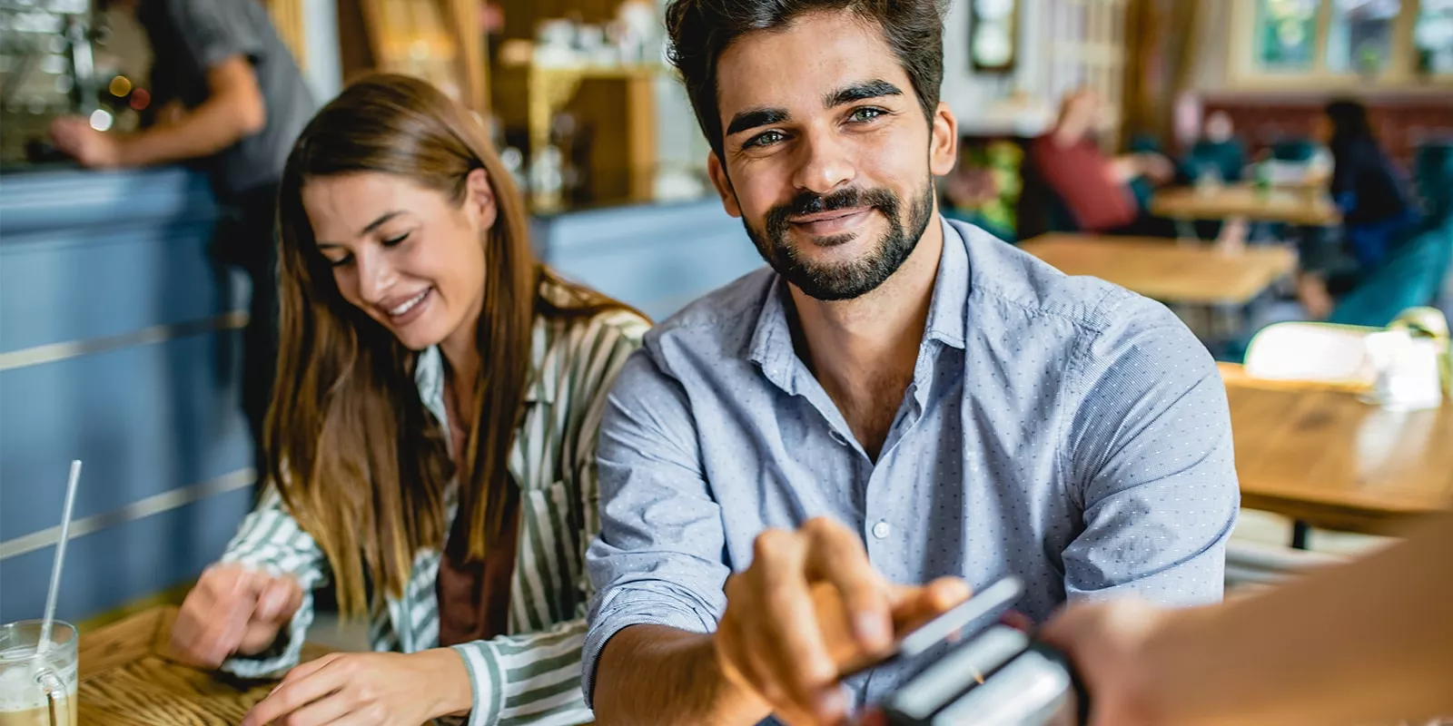 man paying for meal in restaurant