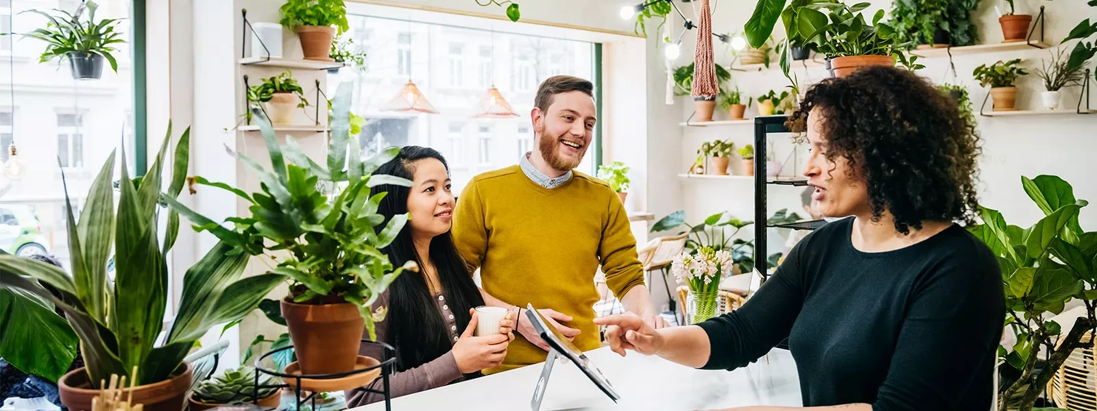 people in small business plant shopping