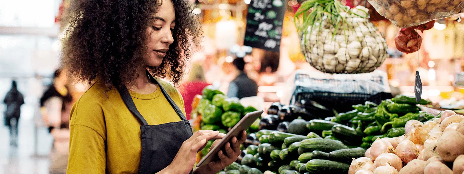 grocery store employee using tablet