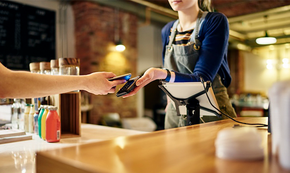 person paying in store wirelessly